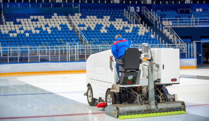 Indoor stadium floor cleaning with equipment