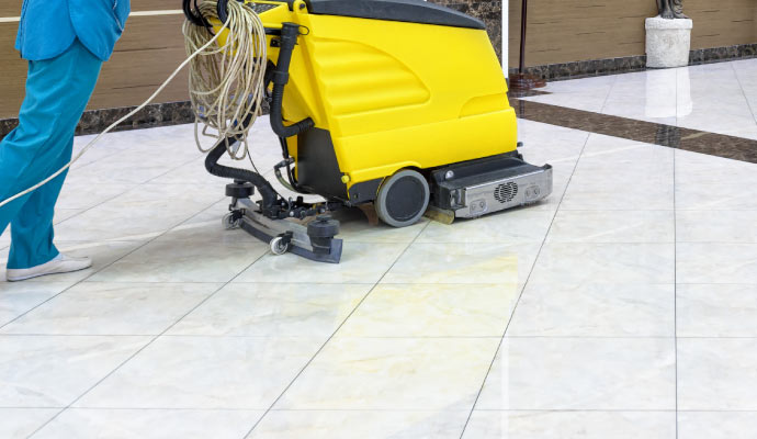 Expert cleaning commercial space using equipment.