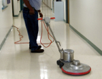 Worker polishing a hallway floor