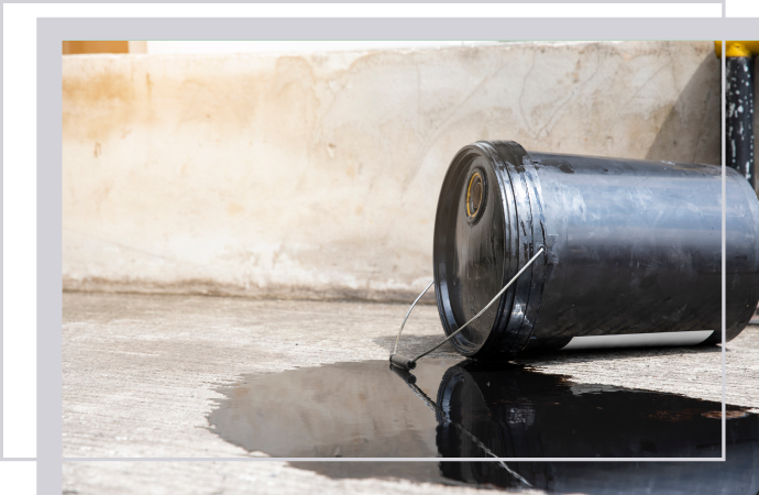 Professional oil spill clean-up needed for leaking barrel on concrete floor