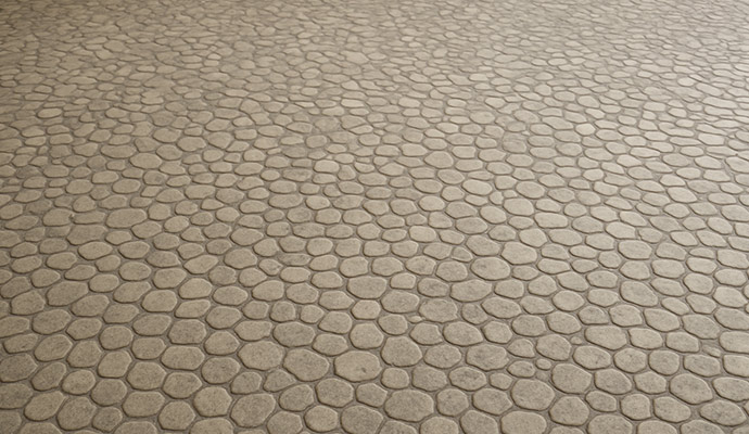 A close-up view of a floor covered in small, rounded pebble tiles