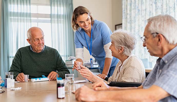 Caregiver assisting seniors in a clean facility