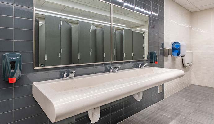 Clean commercial restroom with sink and mirrors