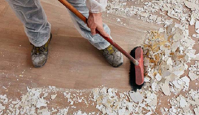 Person cleaning construction debris