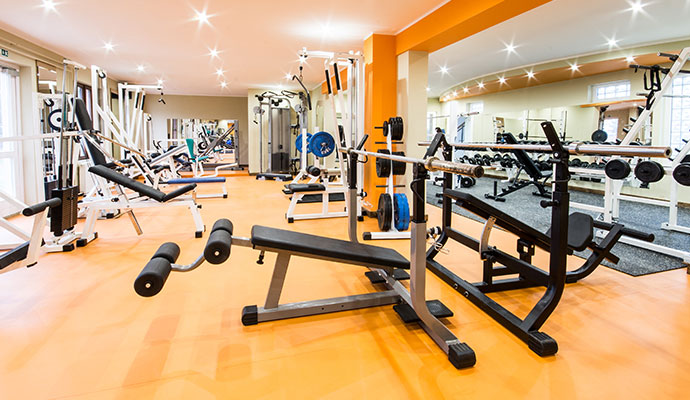 Clean modern fitness gym interior with equipment