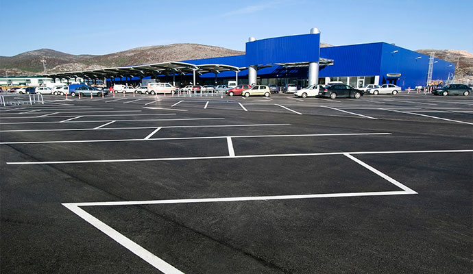 Commercial parking lot with freshly painted stripes in a shopping center 