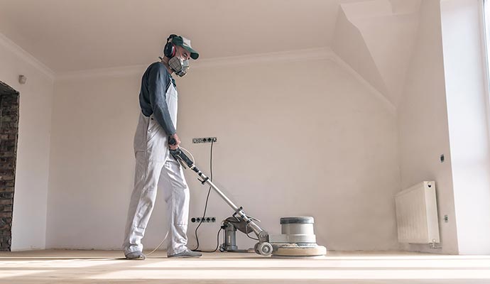 Worker deep cleaning the floor