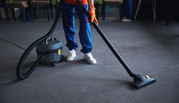 Expert cleaning an office carpet using professional equipment