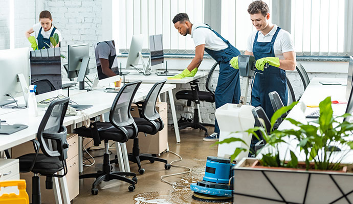 Professional team performing deep cleaning in an office interior