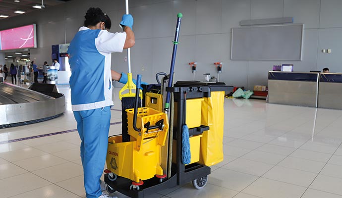 Professional cleaner cleaning airport floor