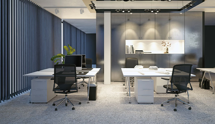 A pristine, modern office with clean white desks and black mesh chairs, perfectly prepared for the next business day by Valor Janitorial.