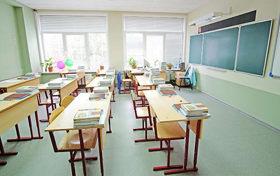 a class room with benchs and clean floor