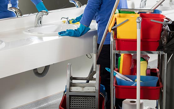 cleanig a white sink in the restroom