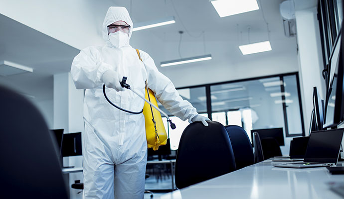 Technician disinfecting office space